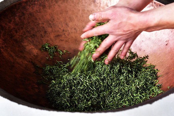 Drying the tea leaves by stir-frying again