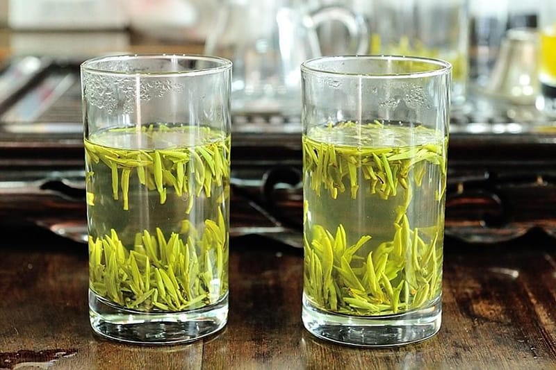 Brewing with a glass cup you can see Junshan Yinzhen tea dancing in the water
